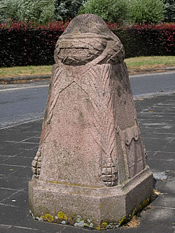 Demarcation Stone No. 16 at Zillebeke, south-east of Ypres in Belgium with a British helmet on the top.