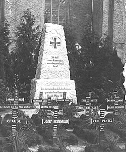 German graves and memorial from 1915 in a church graveyard in the Flanders battlefields of the Ypres Salient.