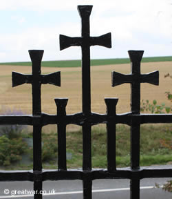 Feature with the five crosses on the metal entrance gate into Fricourt military cemetery on the Somme.