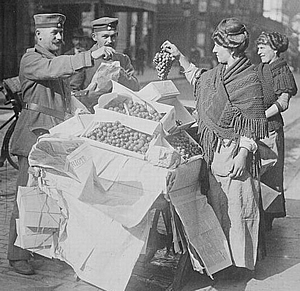 German troops in Belgium buying fruit in Belgium, autumn 1914.